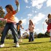 five kids playing outside with hula hoops