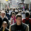 Busy street with people walking towards the camera